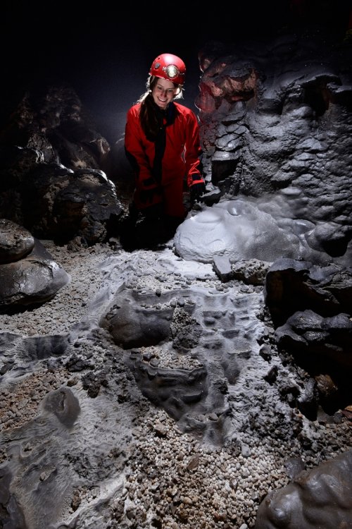Dimnice Jama (Slovénie) - Jeune femme spéléo devant des nids de perles et cailloux blanc et gris(SP-17-0499)